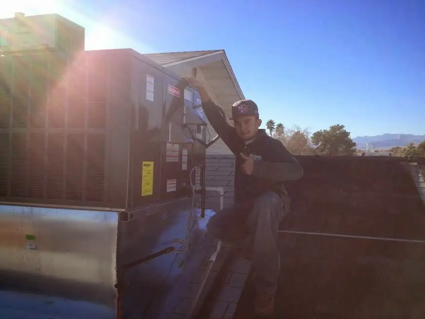 HVAC technician performing HVAC Inspection on a rooftop unit in Marietta